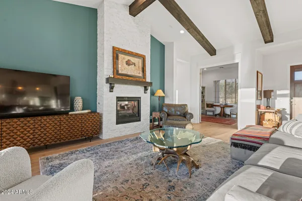 a living room with furniture and a floor to ceiling window