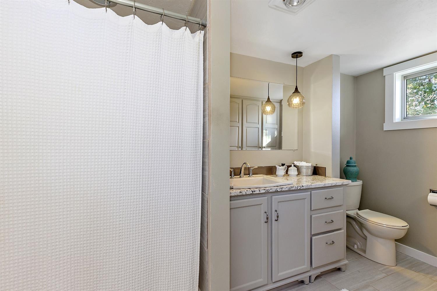 1876 North Valley View Road Ashland, OR 97520 - Photo 20 of 35 a bathroom with a toilet a sink and mirror