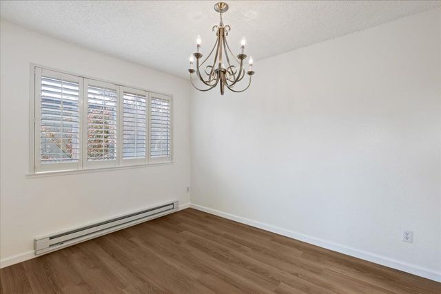a view of a room with wooden floor and windows