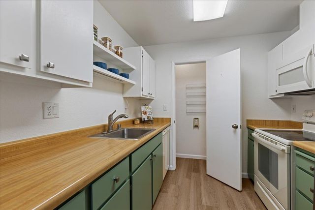 a kitchen with stainless steel appliances granite countertop a sink and a stove