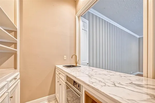 a bathroom with a granite countertop sink and a window