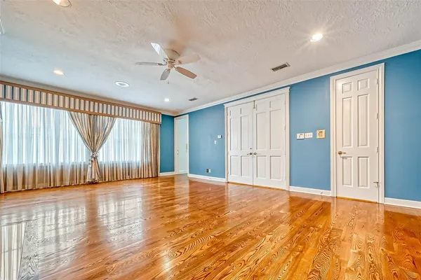 a view of an empty room with a fireplace and a window