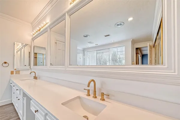 a bathroom with a tub sink shower and mirror