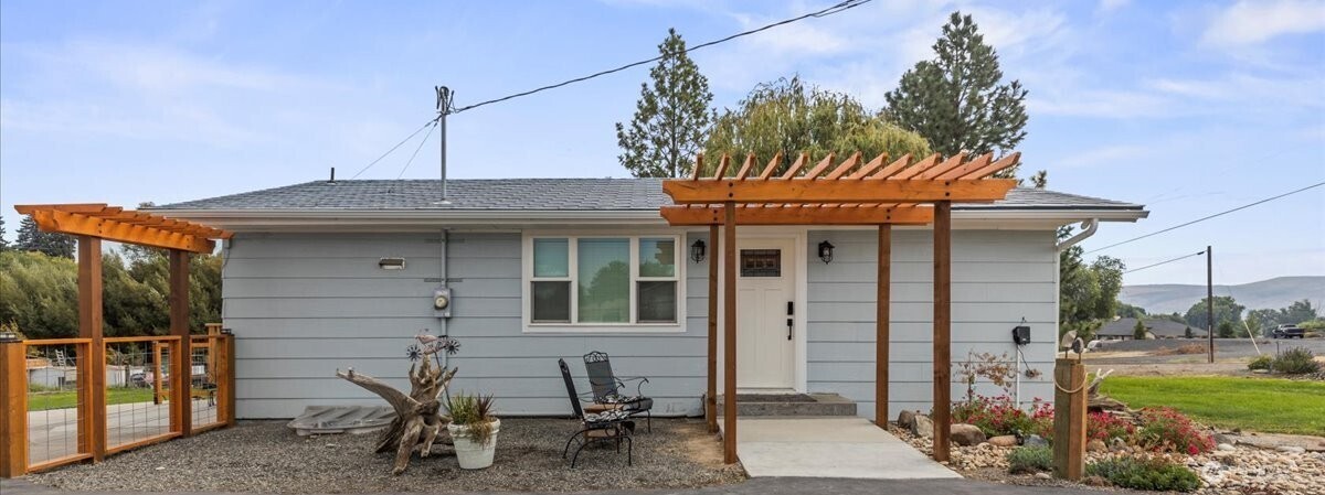 770 Lancaster Road Selah, WA 98942 - Photo 2 of 37 a view of a wooden house with a chairs and table in a patio
