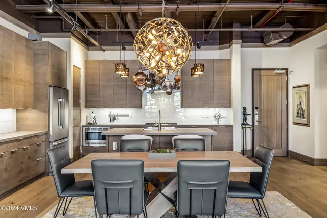 a kitchen with a table and chairs in it