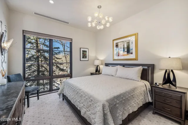 a bedroom with a large bed and a dresser