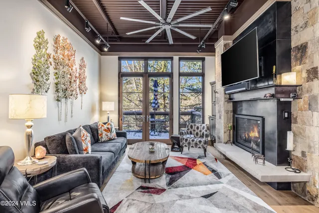 a living room with furniture fireplace and flat screen tv