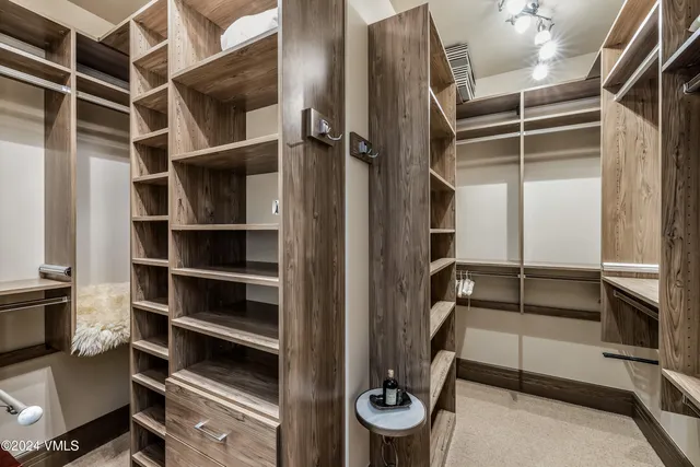 a bedroom with a bed and a flat tv screen on a dresser