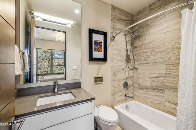 a view of a balcony with wooden floor and fence