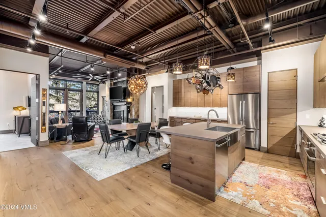 a living room with stainless steel appliances granite countertop lots of counter top space