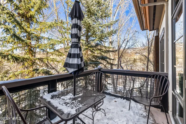 a view of balcony with wooden floor and outdoor seating