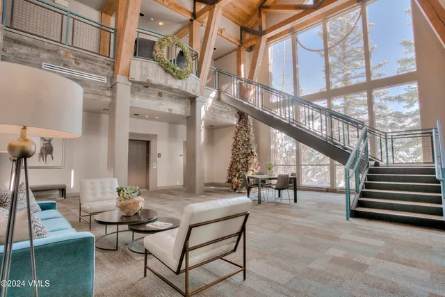 a room with gym equipment and large windows