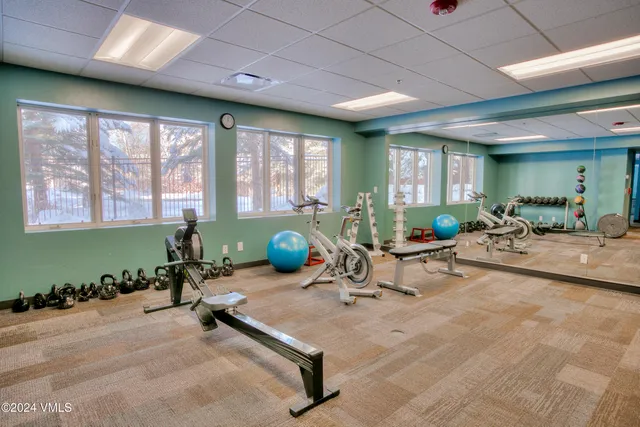 a view of a hallway with stainless steel appliances
