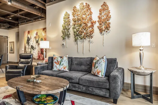 a living room with furniture and a lamp