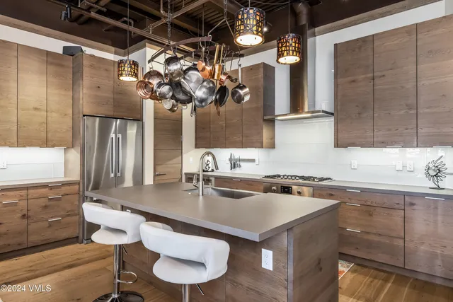 a kitchen with a sink a counter and cabinets