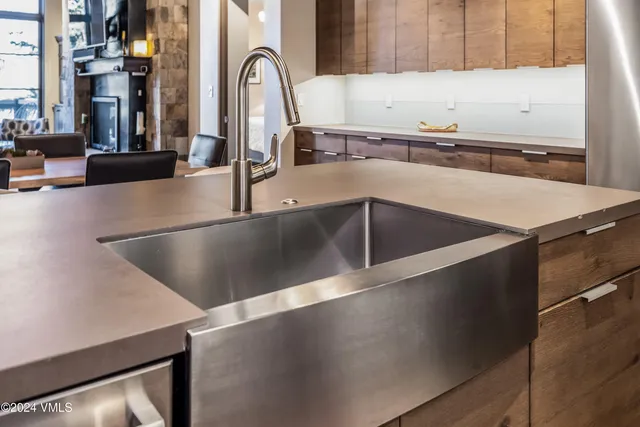 a kitchen with a table chairs and stove