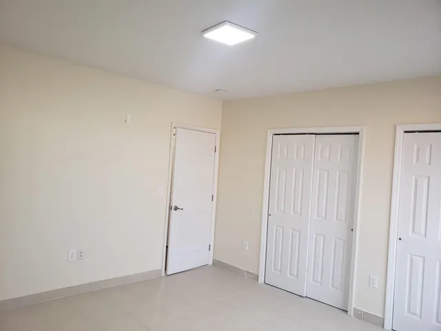 an empty room with closet area