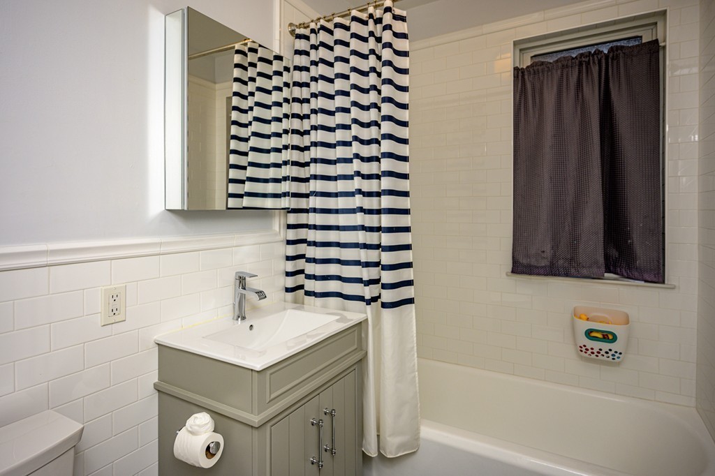 36 Stanton Road, Unit 1 Brookline, MA 02445 - Photo 12 of 17 a bathroom with a sink and a mirror