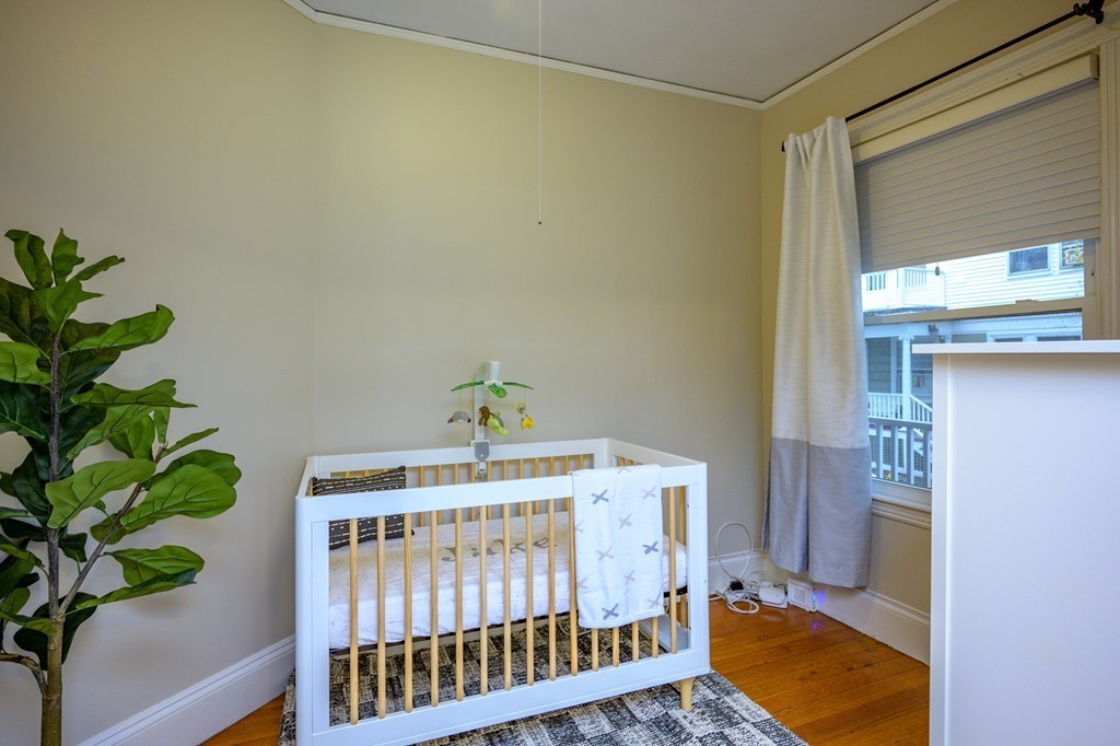 36 Stanton Road, Unit 1 Brookline, MA 02445 - Photo 13 of 17 a bedroom with a bed and a potted plant