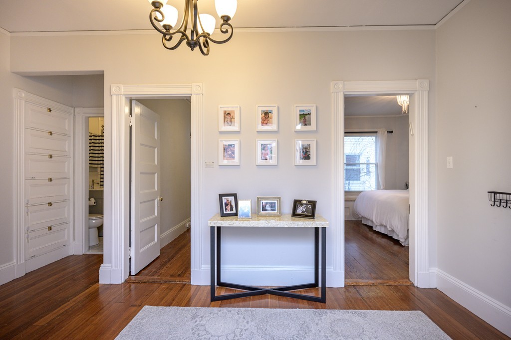 36 Stanton Road, Unit 1 Brookline, MA 02445 - Photo 4 of 17 a view of a hallway with wooden floor and closet
