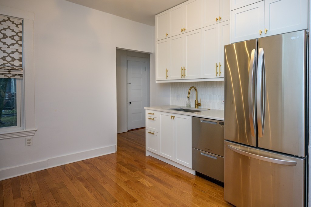 36 Stanton Road, Unit 1 Brookline, MA 02445 - Photo 6 of 17 a kitchen with a refrigerator sink and cabinets