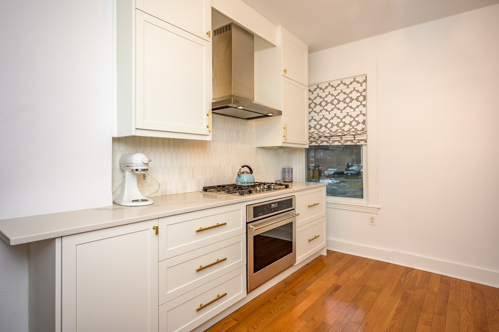 36 Stanton Road, Unit 1 Brookline, MA 02445 - Photo 7 of 17 a kitchen with stainless steel appliances white cabinets and a sink
