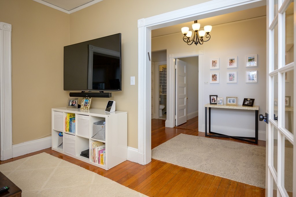 36 Stanton Road, Unit 1 Brookline, MA 02445 - Photo 8 of 17 a bedroom with furniture and a flat screen tv