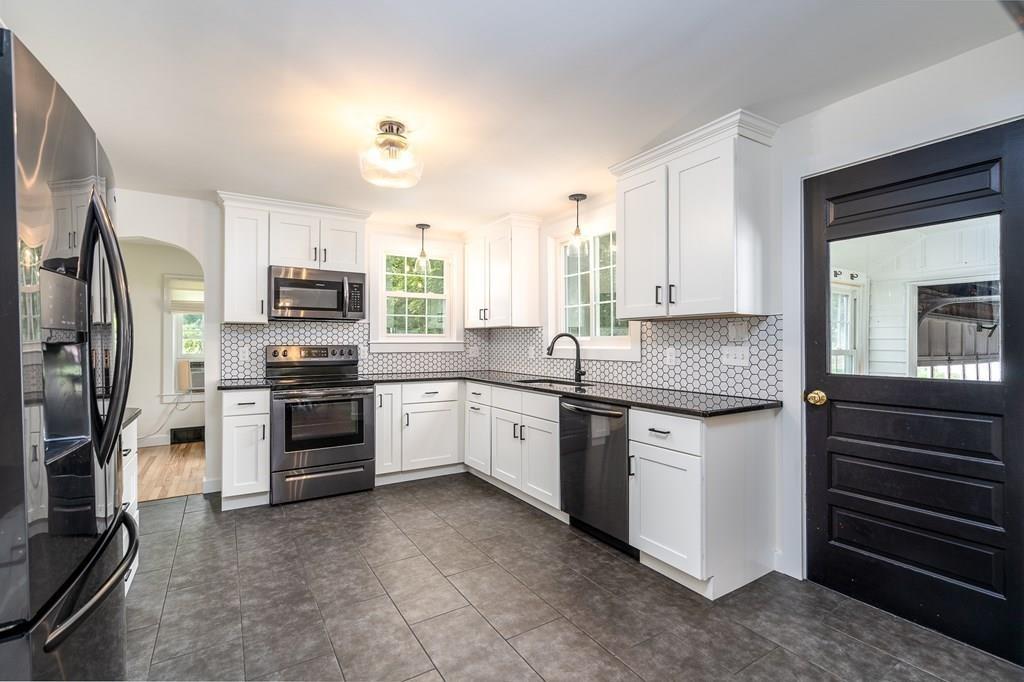 4 Fomer Road Southampton, MA 01073 - Photo 12 of 42 a kitchen with stainless steel appliances granite countertop a refrigerator sink and stove