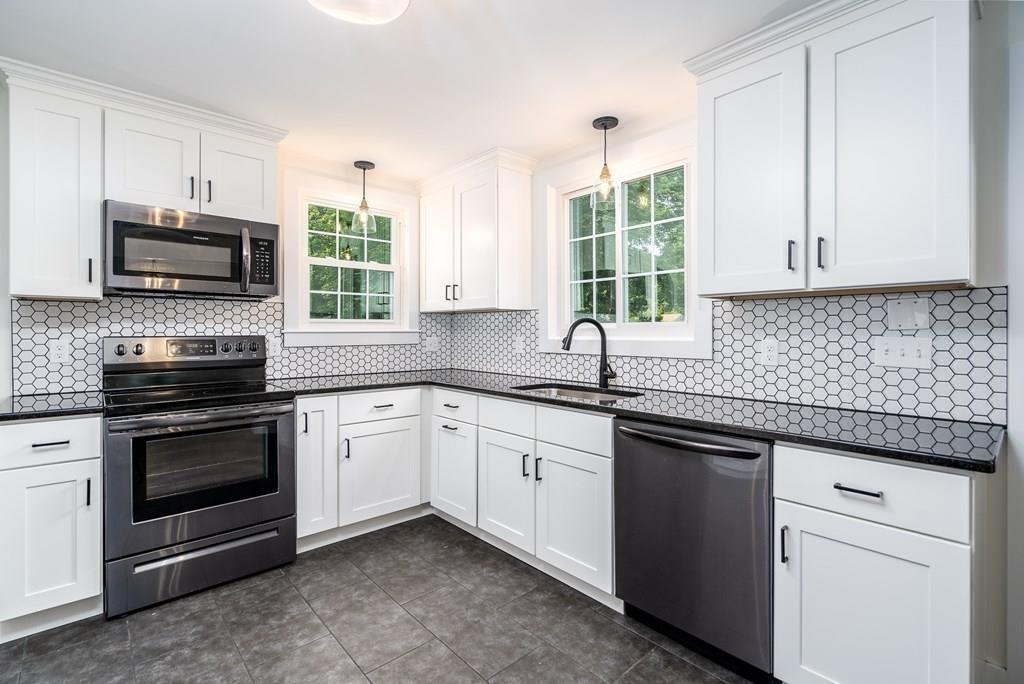 4 Fomer Road Southampton, MA 01073 - Photo 10 of 42 a kitchen with granite countertop white cabinets sink and stainless steel appliances