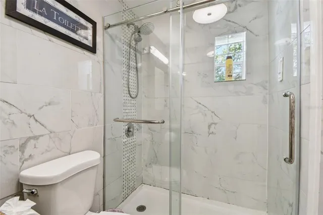 a kitchen with white cabinets and refrigerator