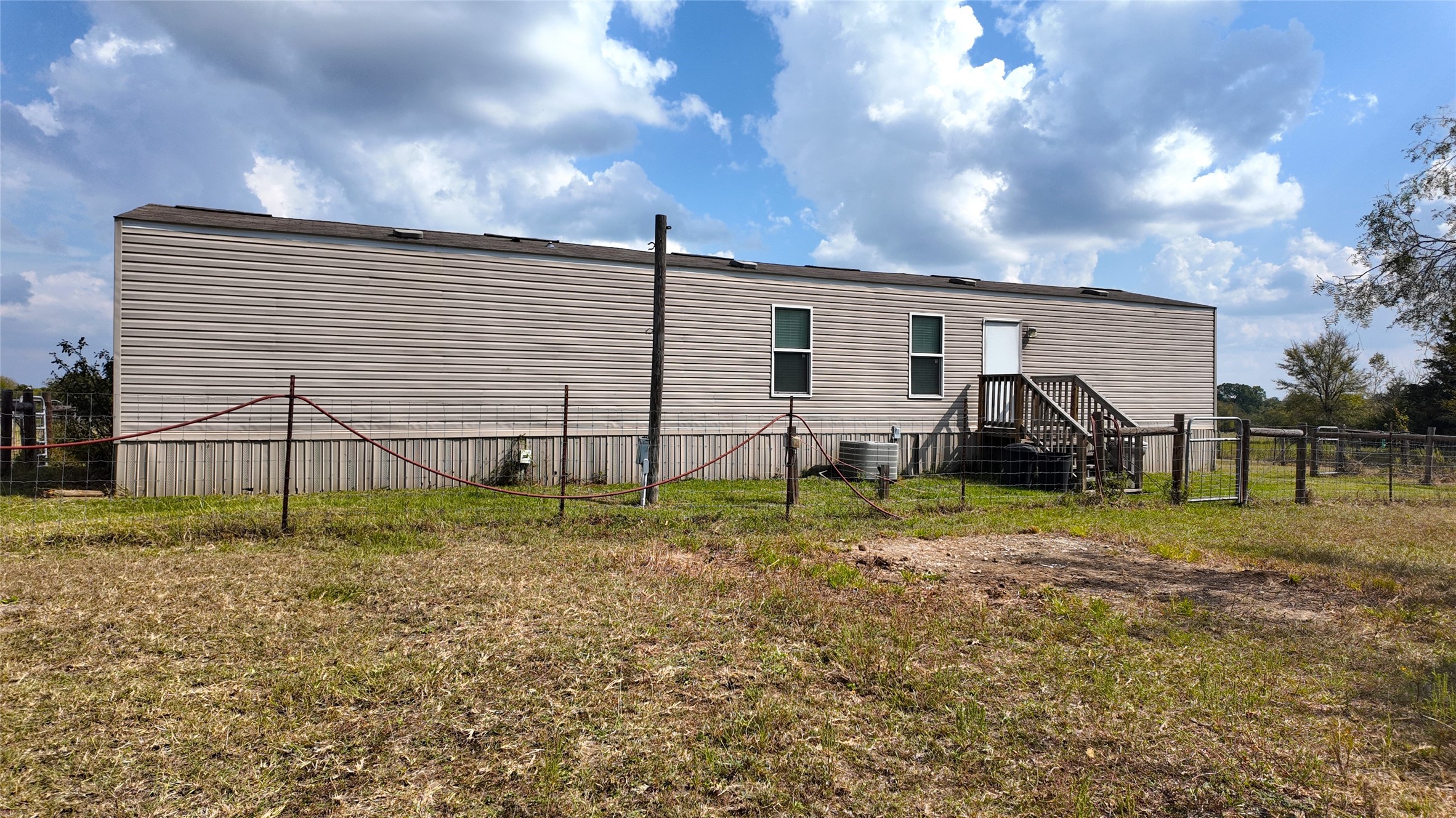 2974 County Road 213 Anderson, TX 77830 - Photo 15 of 50 a backyard of a house with table and chairs