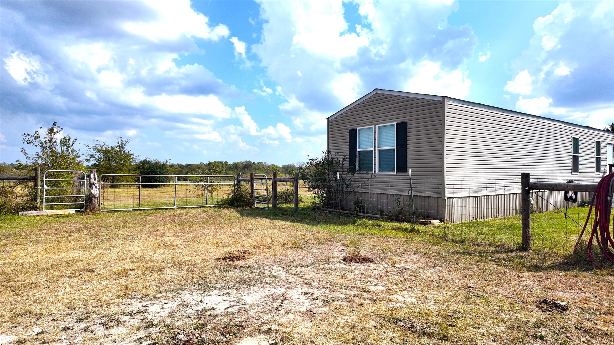 2974 County Road 213 Anderson, TX 77830 - Photo 17 of 50 a backyard of a house with lots of green space and wooden fence