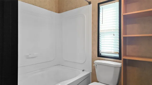 a bathroom with a bathtub and window