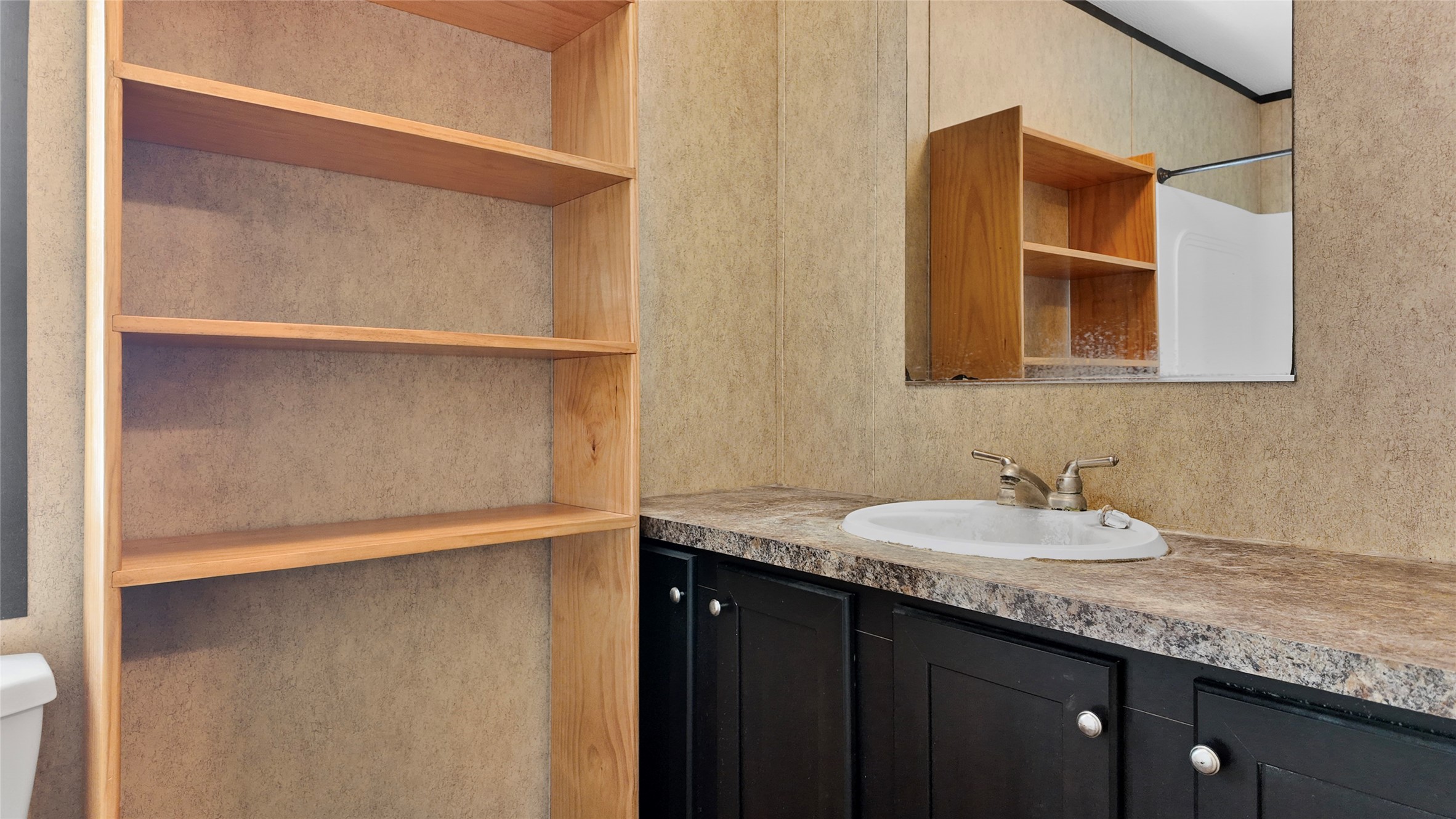 2974 County Road 213 Anderson, TX 77830 - Photo 28 of 50 a bathroom with a granite countertop sink and a mirror