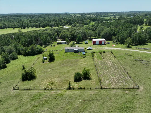 a garden with trees in the background