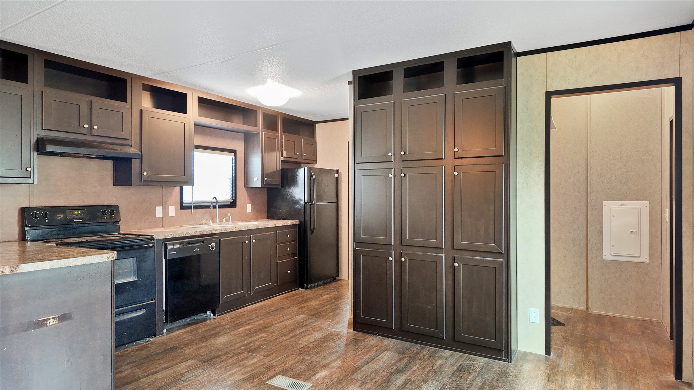 2974 County Road 213 Anderson, TX 77830 - Photo 34 of 50 a kitchen with kitchen island granite countertop wooden cabinets and a refrigerator