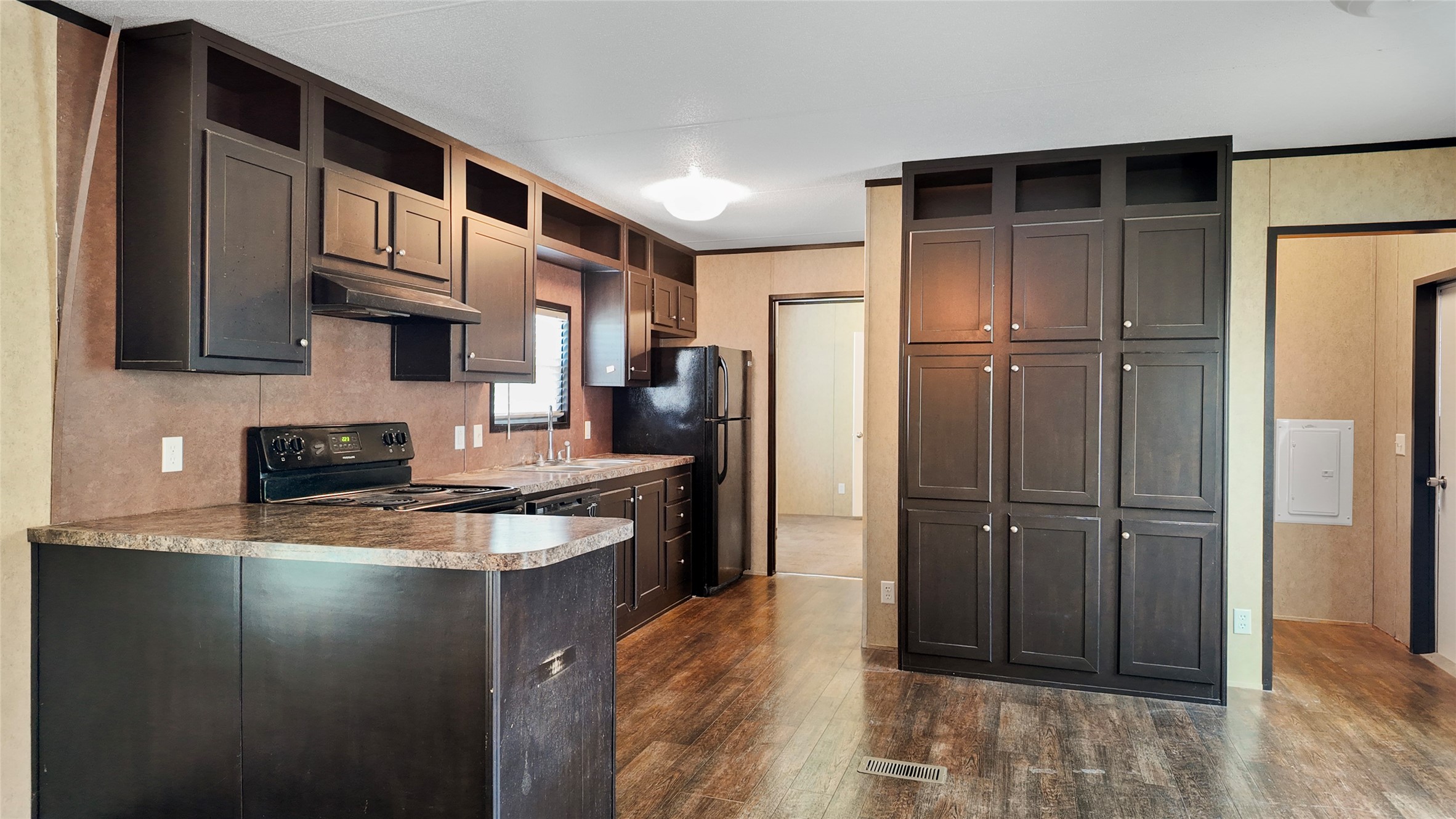 2974 County Road 213 Anderson, TX 77830 - Photo 39 of 50 a kitchen with stainless steel appliances granite countertop a refrigerator a stove and a sink with wooden floor