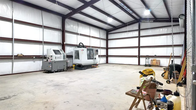a view of a yard with plants and trees