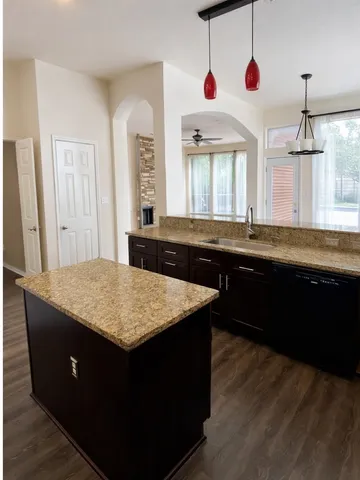 a kitchen with a sink and a wooden cabinets
