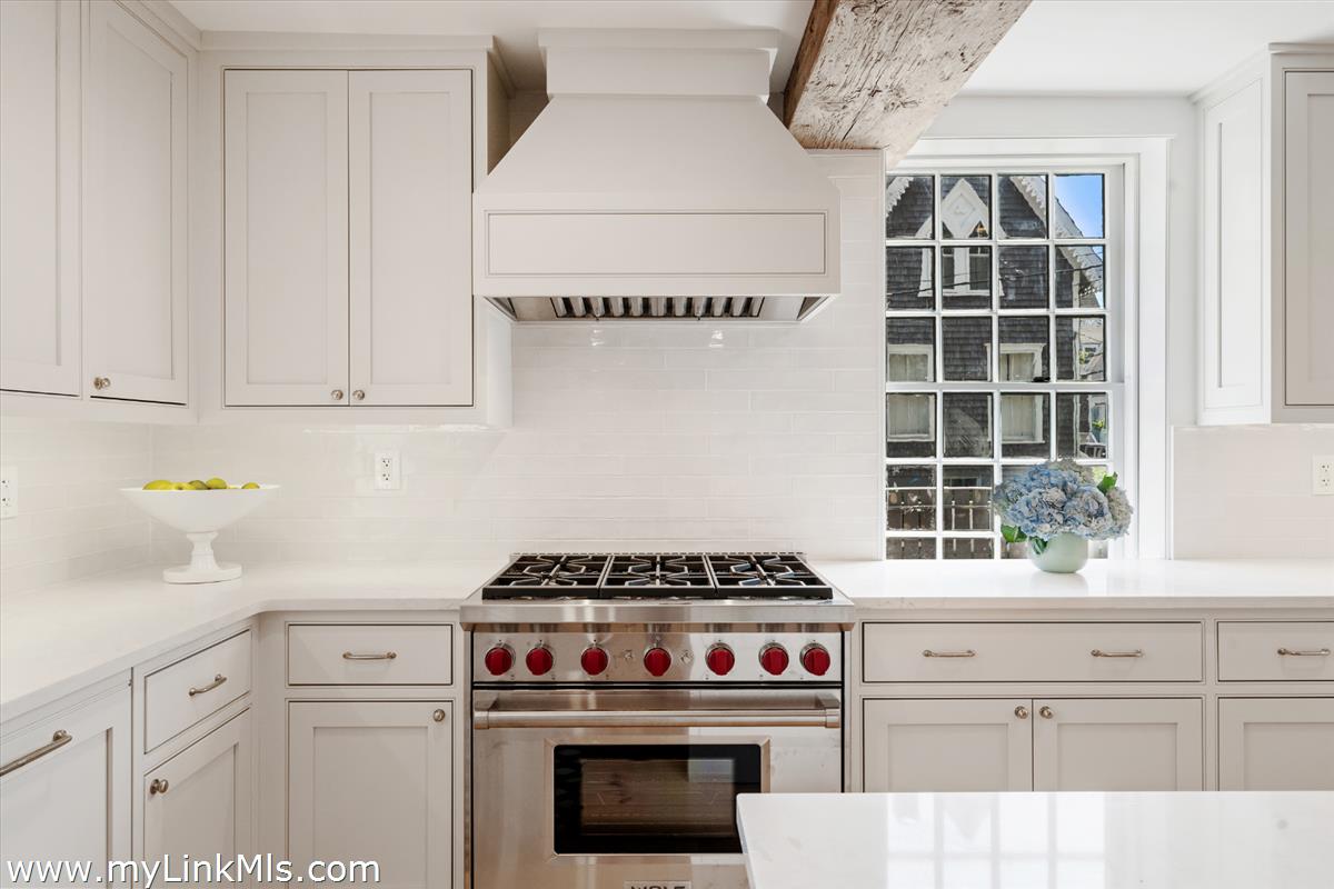 10 North Water Street Nantucket, MA 02554 - Photo 15 of 78 a kitchen with a stove and white cabinets