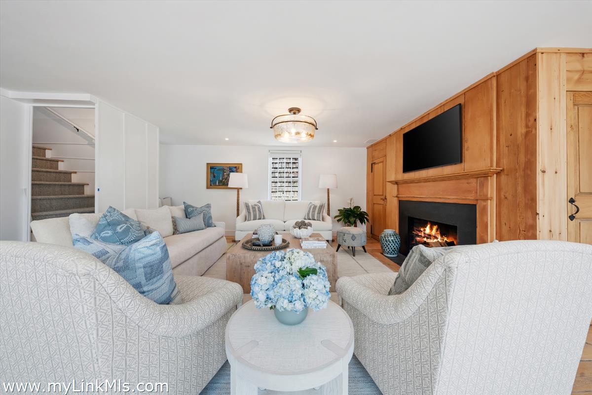 10 North Water Street Nantucket, MA 02554 - Photo 21 of 78 a living room with furniture fireplace and a flat screen tv