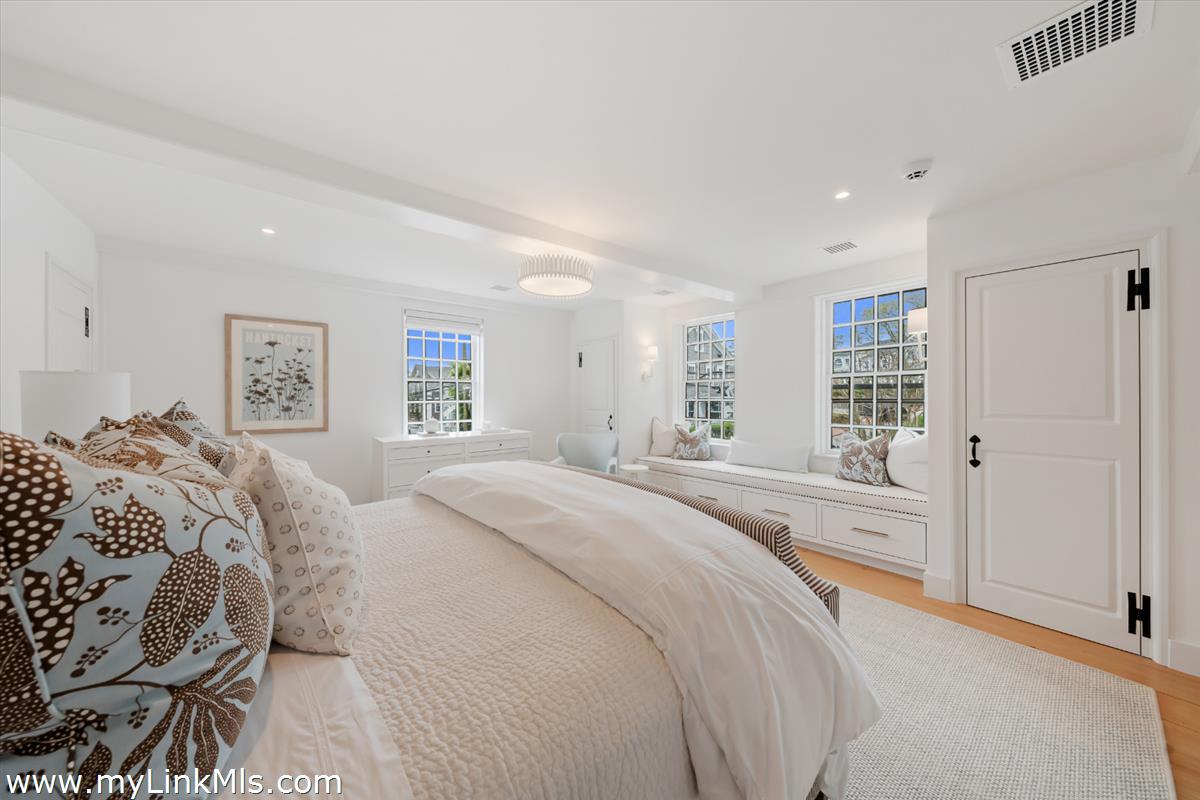 10 North Water Street Nantucket, MA 02554 - Photo 49 of 78 a spacious bedroom with a bed and a large mirror