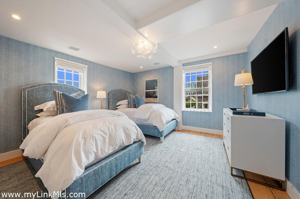 10 North Water Street Nantucket, MA 02554 - Photo 52 of 78 a spacious bedroom with a bed and a flat screen television