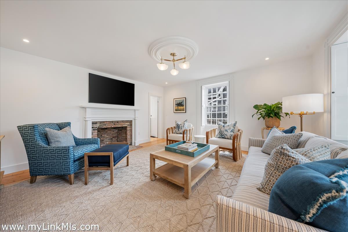 10 North Water Street Nantucket, MA 02554 - Photo 6 of 78 a living room with furniture a fireplace and a flat screen tv