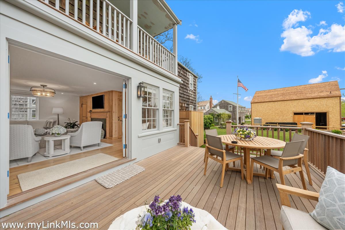 10 North Water Street Nantucket, MA 02554 - Photo 64 of 78 a view of a deck with table and chairs with wooden floor and fence