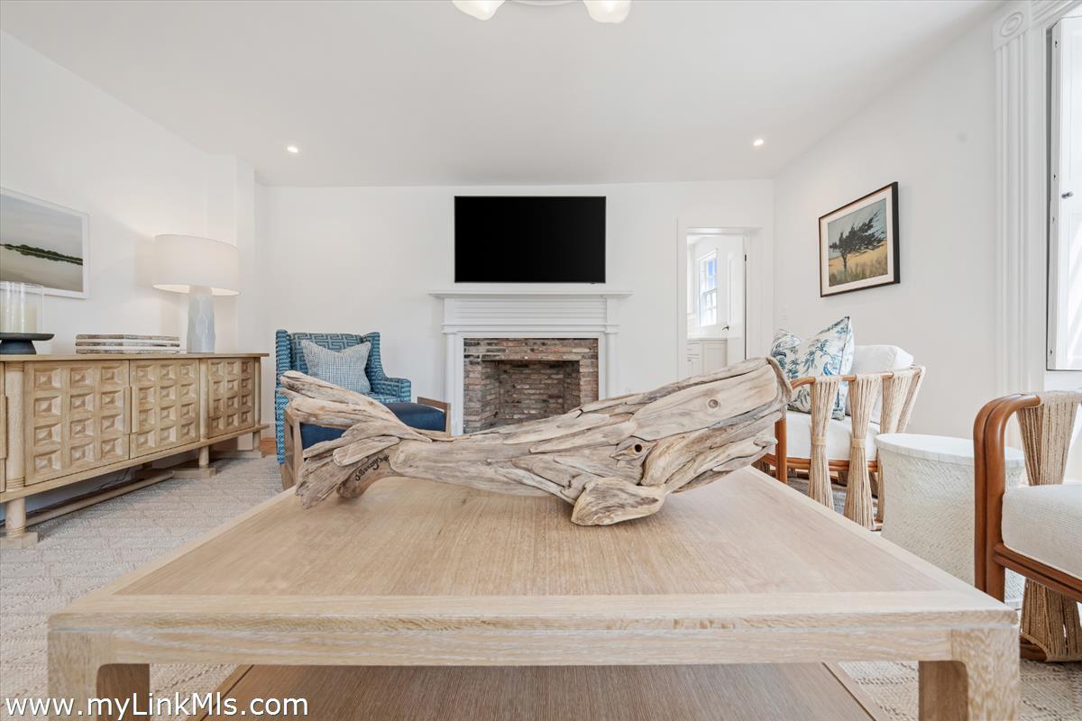 10 North Water Street Nantucket, MA 02554 - Photo 8 of 78 a living room with furniture a flat screen tv and a fireplace