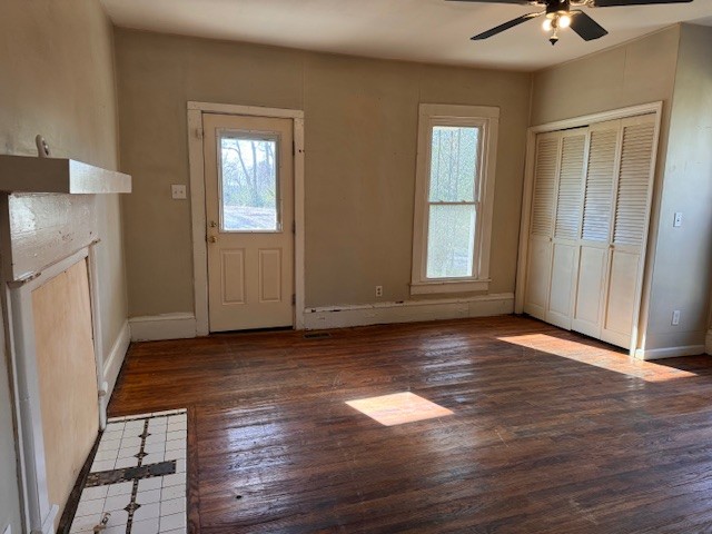 139 Columbia Avenue Centerville, TN 37033 - Photo 24 of 44 an empty room with wooden floor and a kitchen