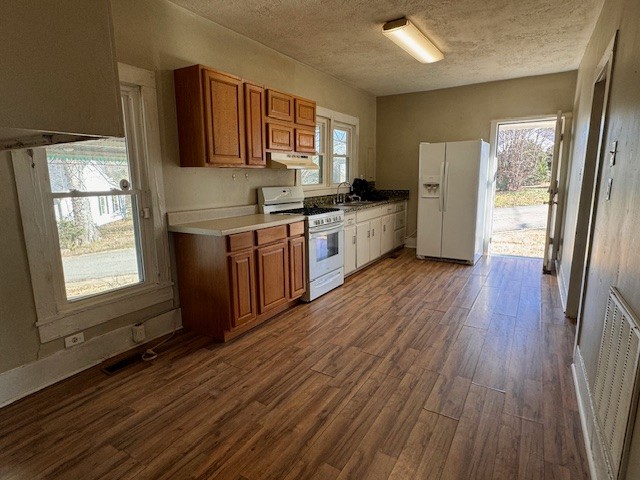 139 Columbia Avenue Centerville, TN 37033 - Photo 39 of 44 a kitchen with stainless steel appliances granite countertop a refrigerator a sink dishwasher a stove with wooden cabinets and wooden floor