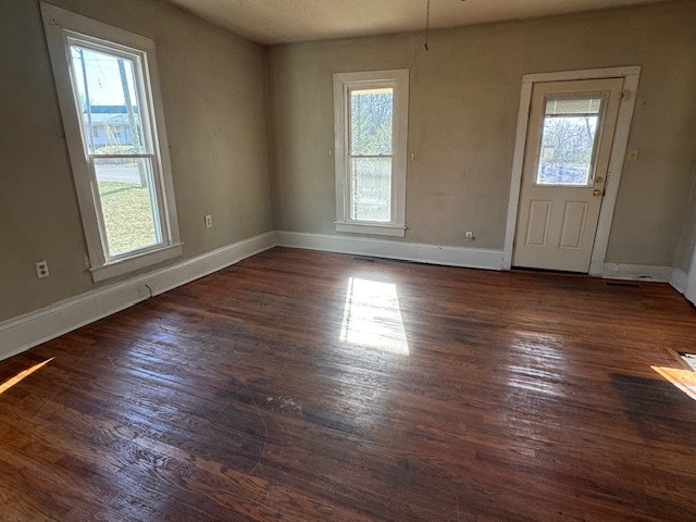 139 Columbia Avenue Centerville, TN 37033 - Photo 40 of 44 an empty room with wooden floor and windows with curtains view