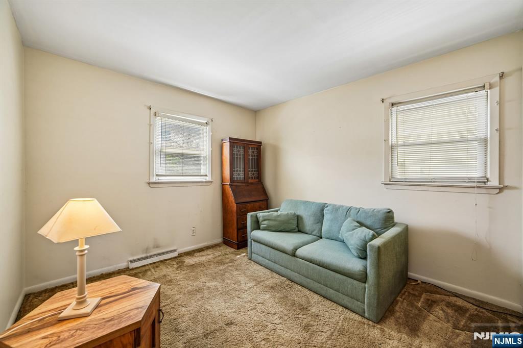 31 Division Street Bloomfield, NJ 07003 - Photo 16 of 30 a living room with furniture and a window